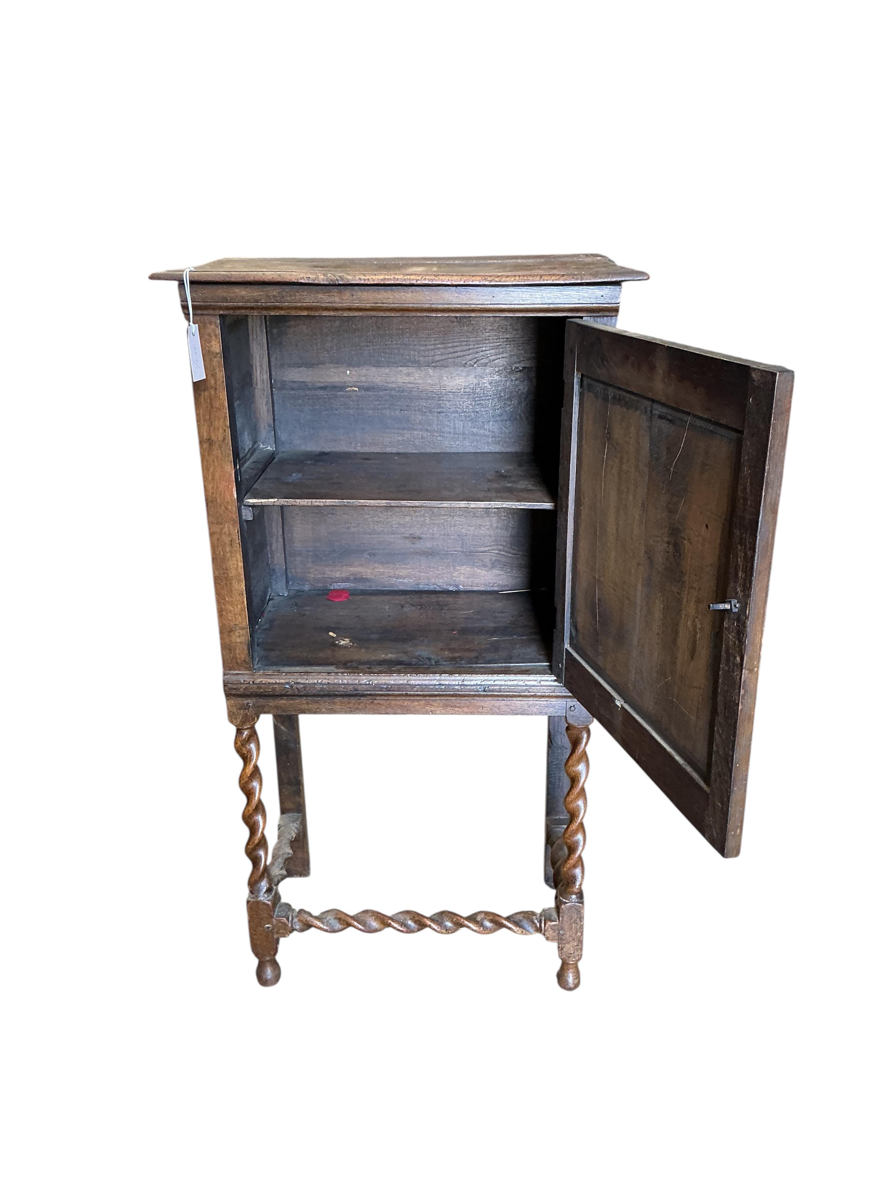 A 17th century style oak cabinet on stand, width 64cm, depth 39cm, height 120cm